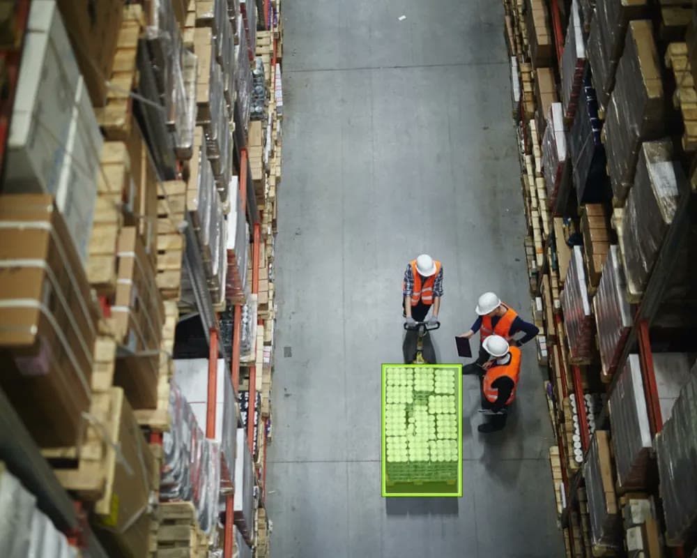 A team reviewing a detected pallet in a warehouse aisle